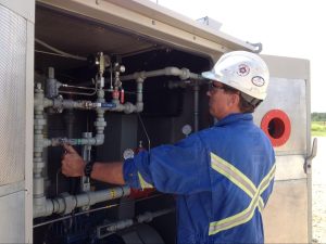A professional inspecting all the parts demonstrates best practices for compressor longevity, from installation to maintenance.