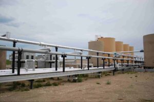 Natural gas compressor station with pipelines and processing equipment used to regulate and move natural gas.